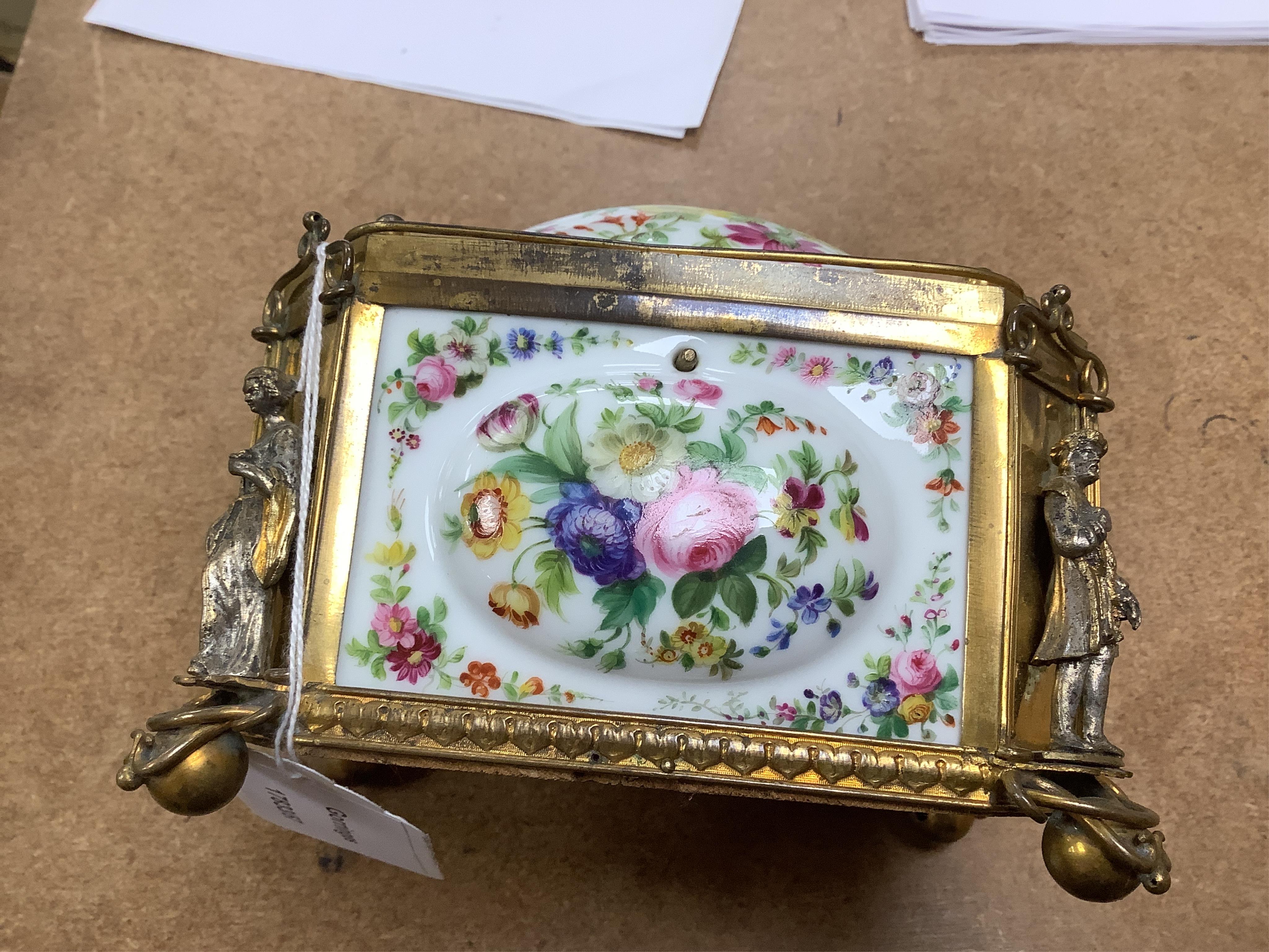 A gilt-brass figural and floral porcelain jewellery casket, 14cm wide, 11cm high.